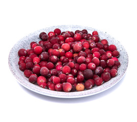 Cranberries in a wicker tray on awhite background
