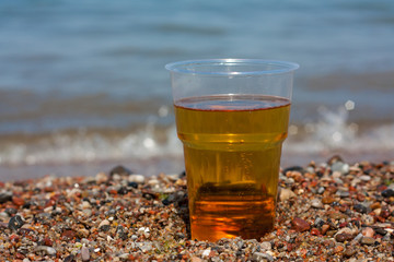 Glass of beer on the sea