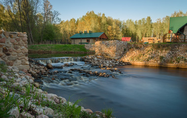 threshold of stones on the river background green grass