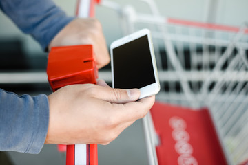 Close up on hand. reading a text message, calling during shopping