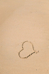 Love heart sign on the wet beach sand sea wave background