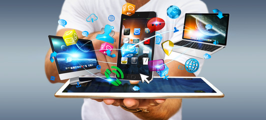 Businessman holding tech devices and icons applications