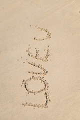 LOVE U sign on wet sand beach background 