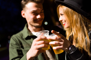 Beautiful young couple visiting eat market in the street.