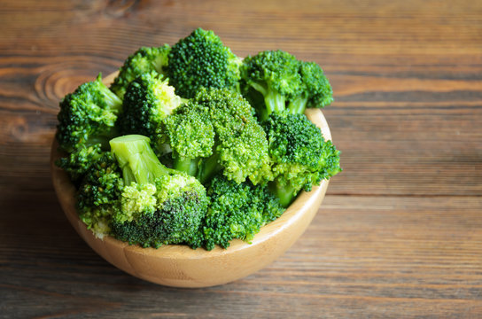 Fresh broccoli in wooden bowl