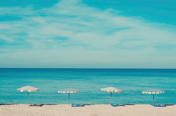 Copy space of umbrella on beach with blue sky background