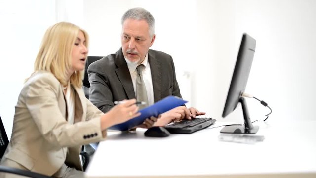 Senior colleagues working in their office