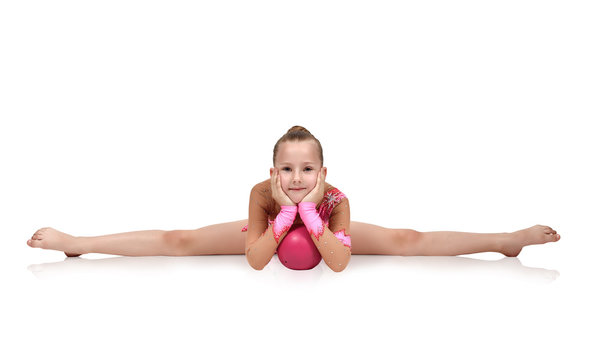 gymnast sitting on split with ball