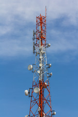 Red and white antenna on blue sky
