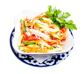 Chinese chicken salad with cucumber and tomatoes.