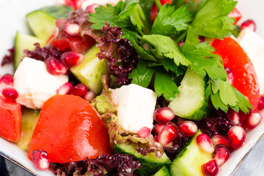 Tomato salad with feta cheese and pomegranate.