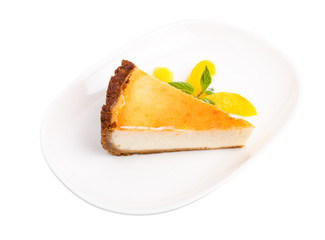 Classic cheesecake with mint and sliced peach.
