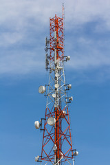 Red and white antenna on blue sky