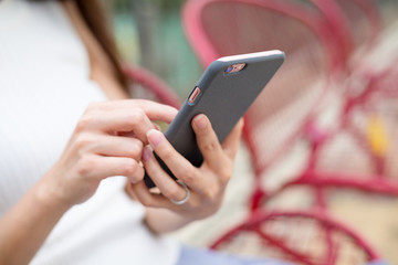 Woman sitting down and using the cellphone