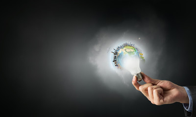 Glowing bulb in hand