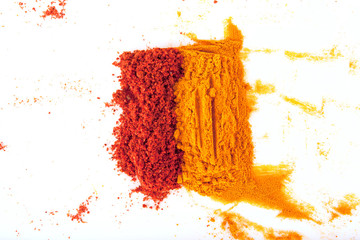 Turmeric (Curcuma) and paprika powders isolated on white background.