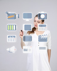 Woman pressing multimedia and entertainment icons on a virtual background