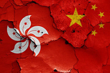 Fototapeta premium flags of Hong Kong and China painted on cracked wall