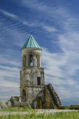 Fototapeta na wymiar bell tower of the old church against the blue sky