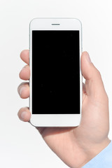 Closeup on hand holding black screen smartphone on white background
