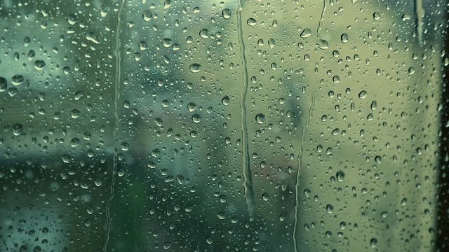 Real Rain is Crashing onto the Window of a Room during a Storm.