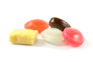 Sweet and milk flavored candy on white background