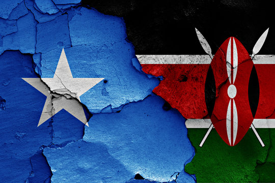 flags of Somalia and Kenya painted on cracked wall