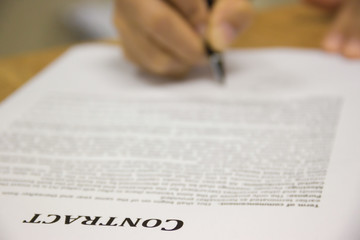 Business worker signing the contract to conclude a deal. selected focus.