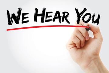 Hand writing We Hear You with marker, business concept background