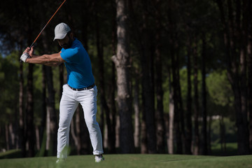 golf player hitting shot