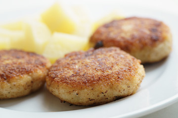 prepared fried fish cakes with boiled potatoes, shallow focus