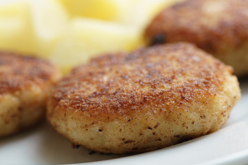prepared fried fish cakes with boiled potatoes, shallow focus