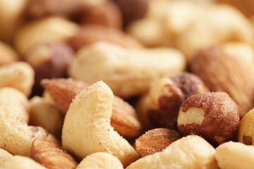 salted nut mix background, closeup shallow focus
