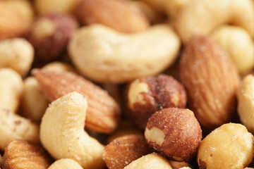 salted nut mix background, closeup shallow focus