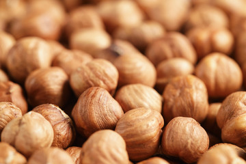 peeled hazelnuts close up background, food backdrop
