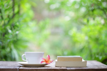 Notebook with pencil and cup on wooden table