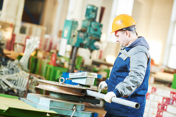 industrial factory worker with tube bending machine