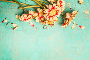 Beautiful flowers bunch on a turquoise shabby chic background , top view, border. Festive greeting...