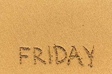 Friday - inscription by hand on a light-golden beach sand..
