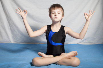 The young boy practices yoga