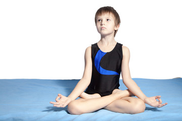 Fototapeta premium The young boy practices yoga