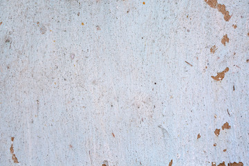 Cracked white paint on a wall of clay. Grunge wall of the old house, textured background