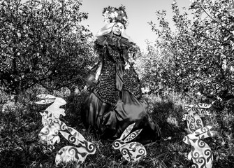 Naklejka premium Dramatized image of sensual girl symbolizing nature. Black-white art fashion outdoor photo.