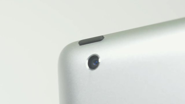 Pressing the ON button of a tablet device.