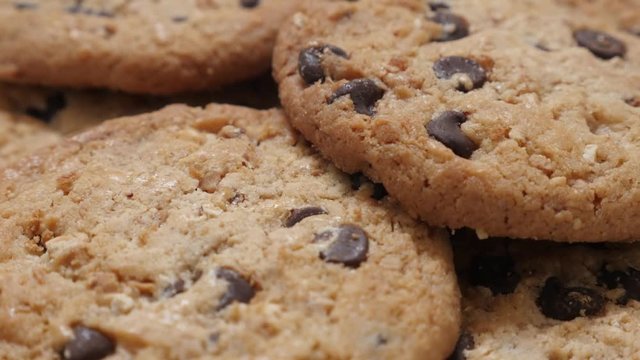 Tasty and fresh chocolate chip cake biscuit close-up slow tilt 4K 2160p 30fps UltraHD video - Tilting over pile of chocolate biscuit cakes food 4K 3840X2160 UHD footage 