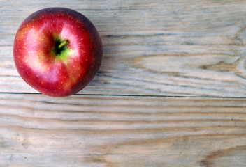 Red apple on a wooden background