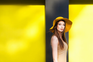 Young girl posing by the color wall