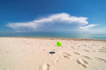 Fototapeta na wymiar Balloon on background of ocean. Beach. Clouds