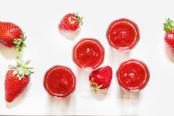 Strawberry juice on white wooden background, not isolated, top v