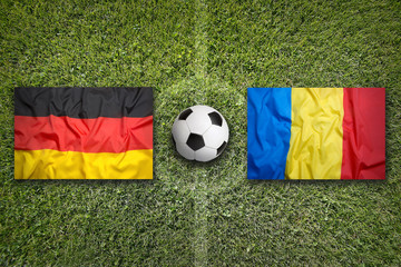 Fototapeta premium Germany vs. Romania flags on soccer field